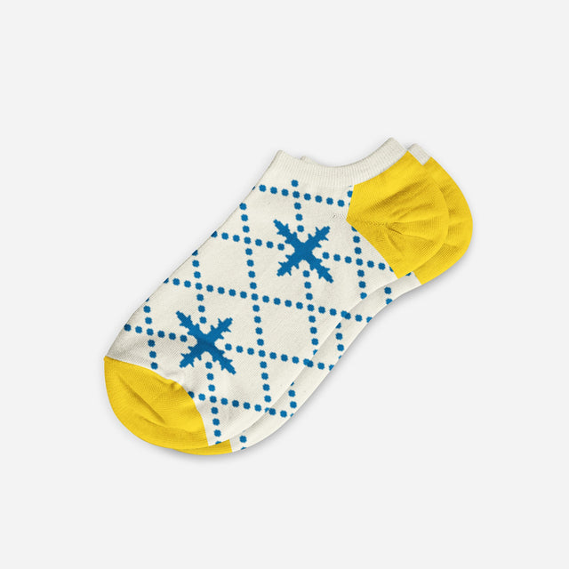 A digital mockup of blue floral ankle socks with yellow toe and heels, on a light grey background.