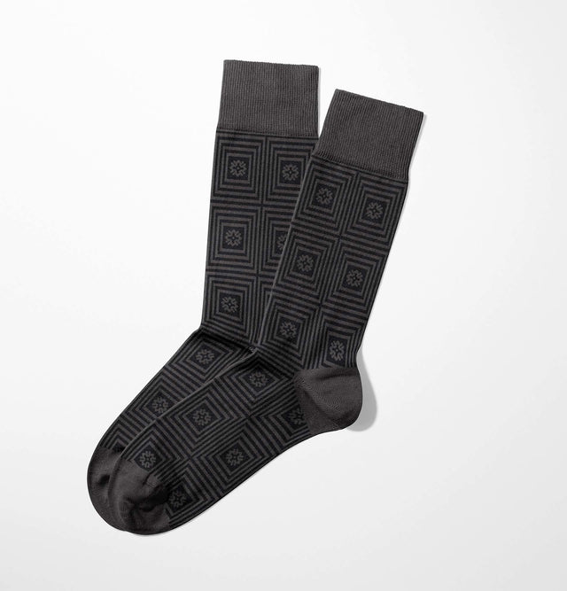 These unisex Squares Grey Socks feature a striking geometric square and star pattern on a crisp white background, crafted from luxurious Egyptian cotton for unmatched comfort.