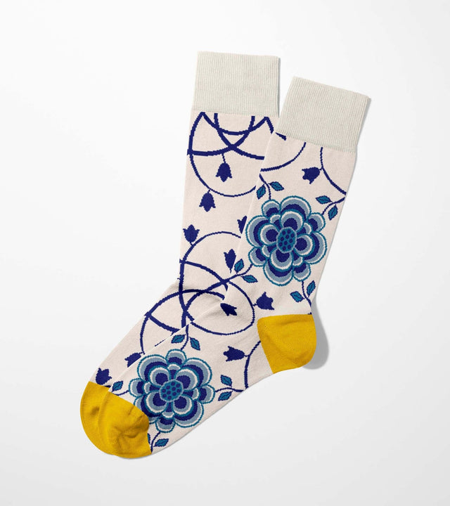 A digital mockup of blue camellia socks with yellow toe and heels, on a light grey background.