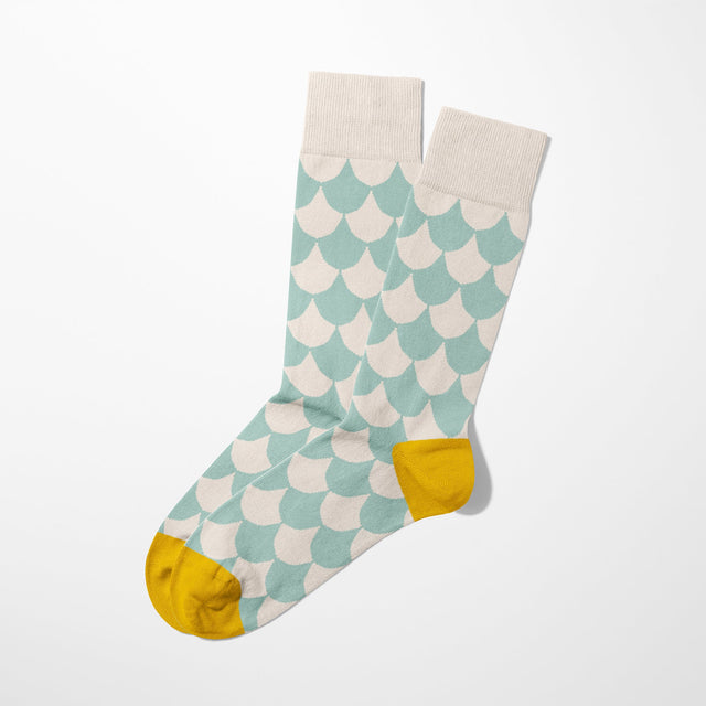 A digital mockup of lima-5 socks with yellow toe and heels, on a light grey background.