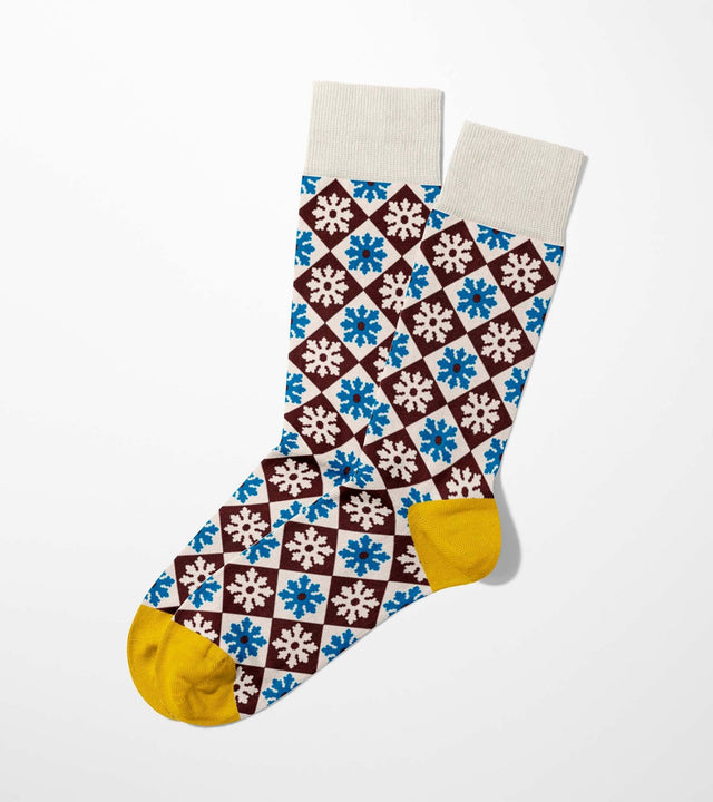 A digital mockup of stylized floral socks with yellow toe and heels, on a light grey background.